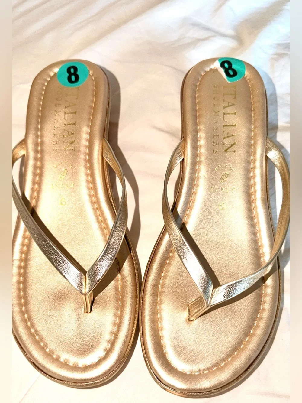 Italian Shoemakers thong wedge sandals feature a metallic gold finish